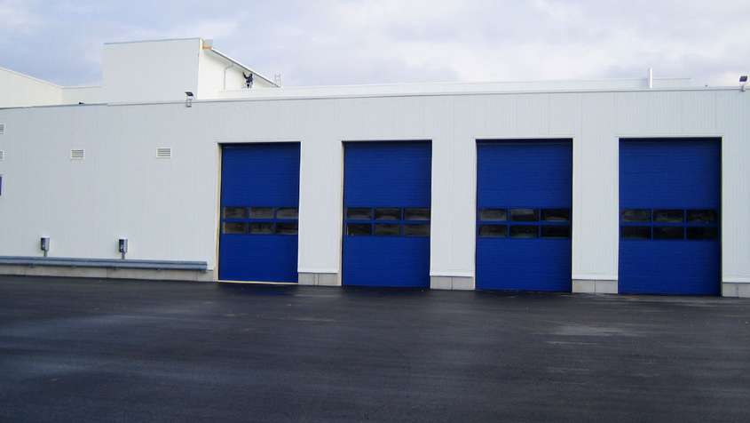 White building with blue sectional doors