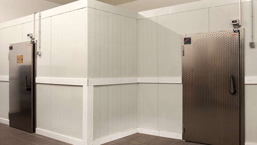 White wall with two doors at the left and right sides of the picture