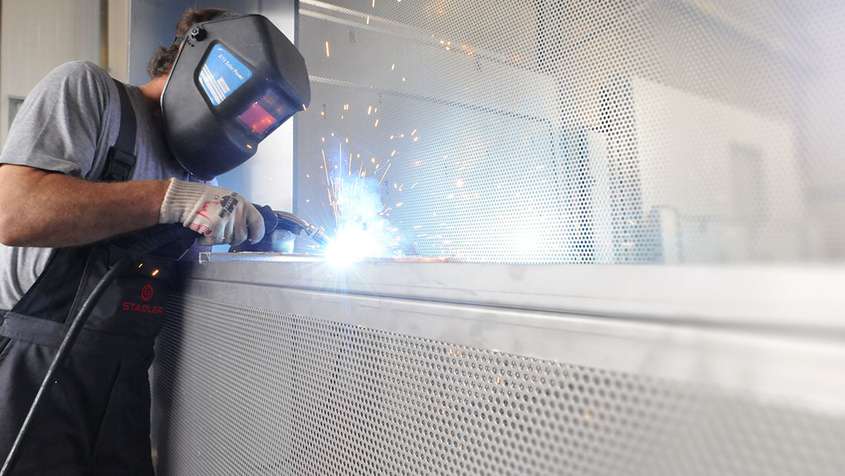 A man welding a box