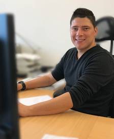 Portrait of a young man sitting at a desk