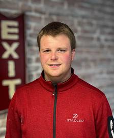 Portrait of a short-haired man wearing a red Stadler jacket